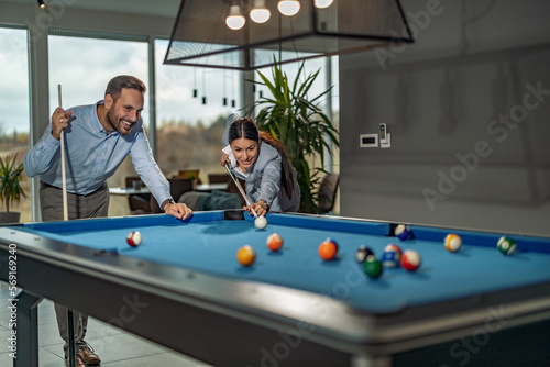 Konstfotografi Business colleagues playing billiards at office after work