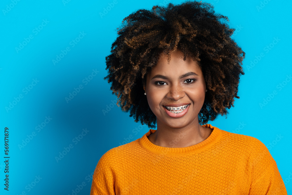 Portrait of attractive smiling black woman posing on blue Portrait of attractive smiling black woman posing on blue