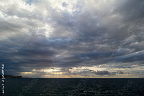 Cliff in a seascape with clouds at dusk