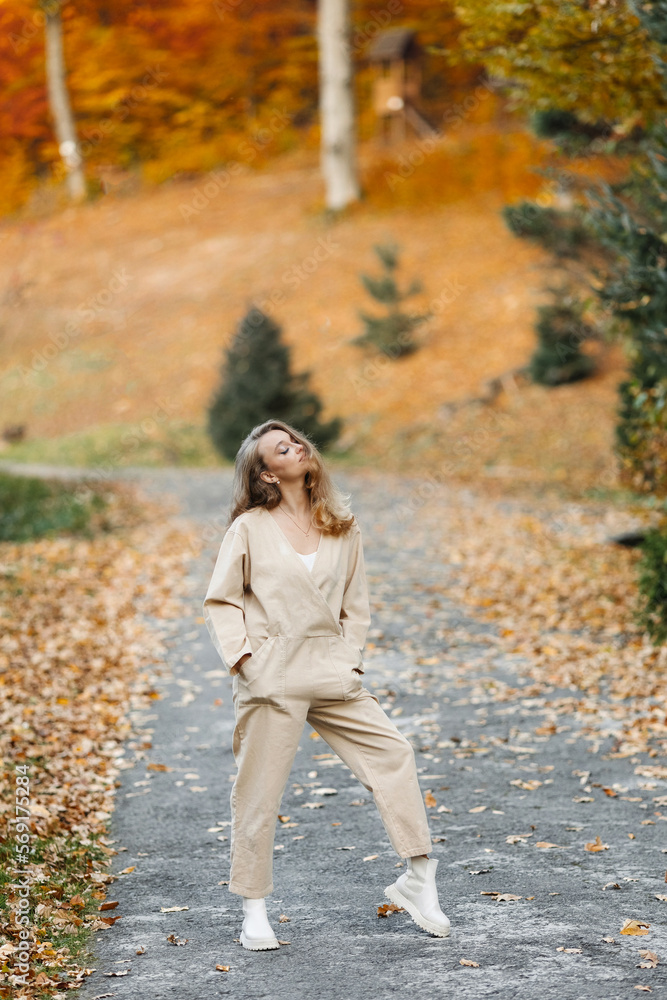 Smiling happy active woman on the path in autumn near the forest Smiling happy active woman on the path in autumn near the forest