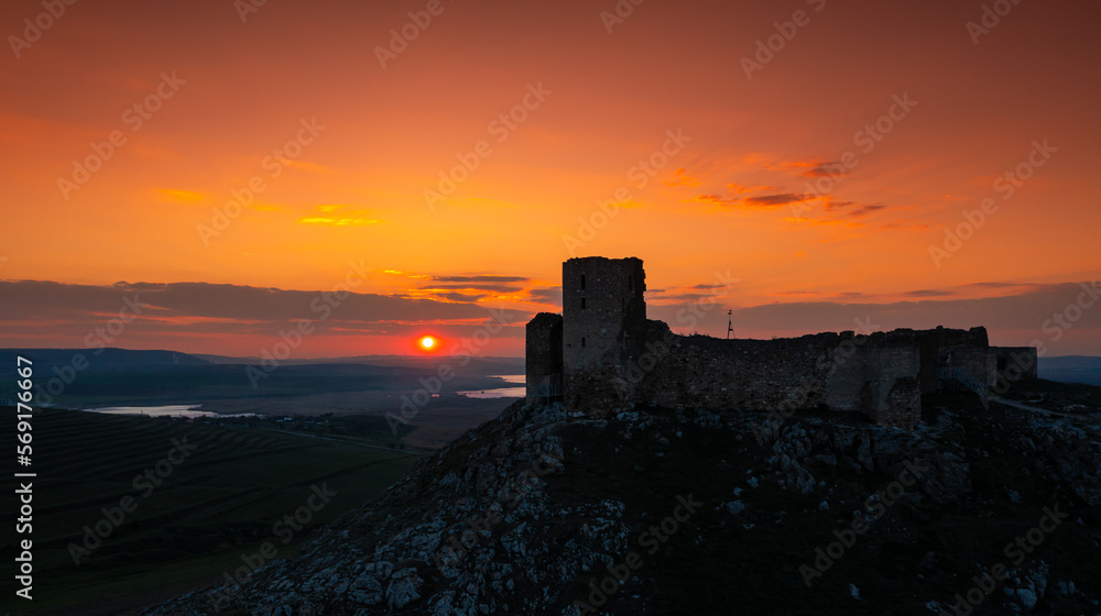 Sunset over Enisala Fortress and village. Aerial view with a beautiful sunset over this landmark place from Dobrogea, Romania. Sunset over Enisala Fortress and village. Aerial view with a beautiful sunset over this landmark place from Dobrogea, Romania.
