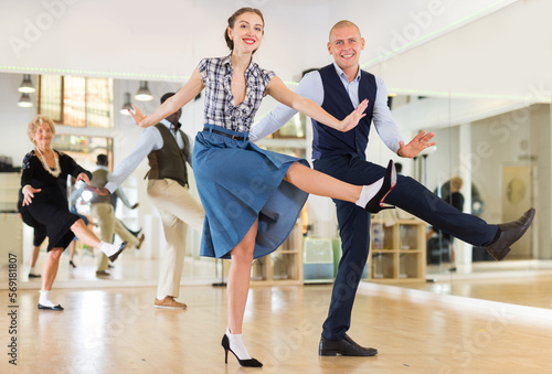 Fototapeta Naklejka Na Ścianę i Meble -  Adult dancing couple enjoying active swing