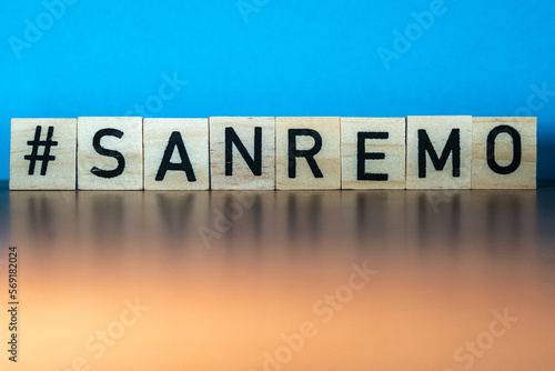 Word Sanremo in wooden letters eith blue background. Italian music festival 2023. Sing concept.music concept. 