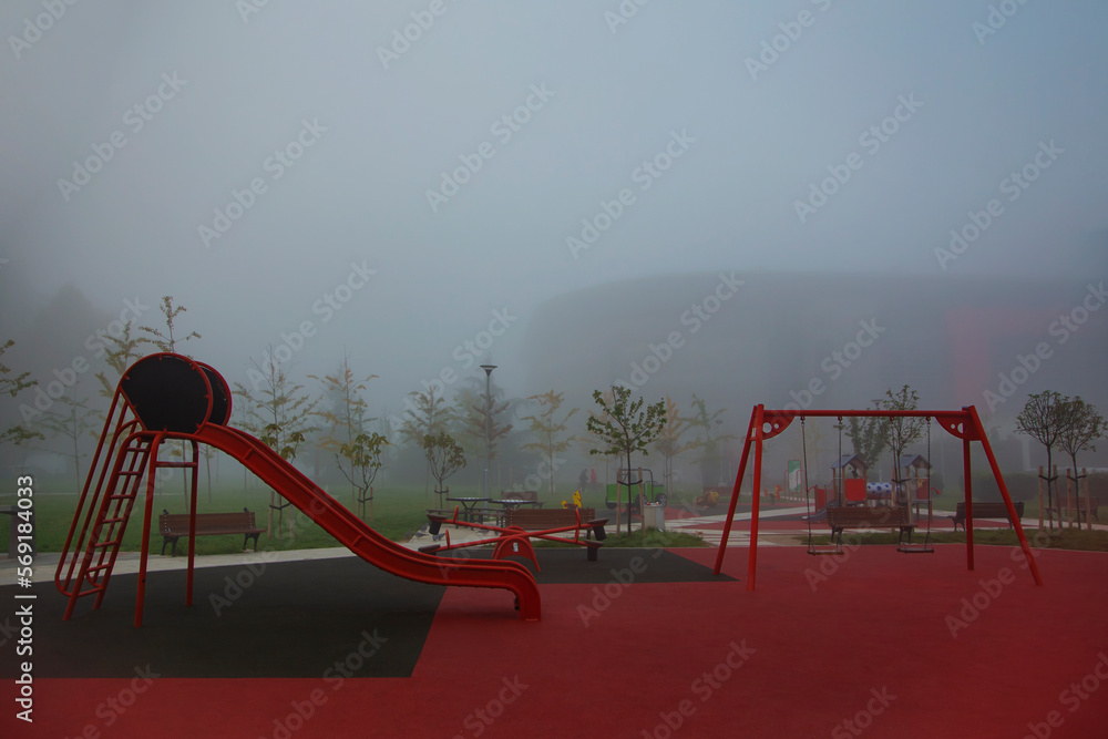 Fototapeta premium Belgrade, Serbia. October 25th, 2022. Empty playground on a cold and foggy winter morning in Belgrade.
