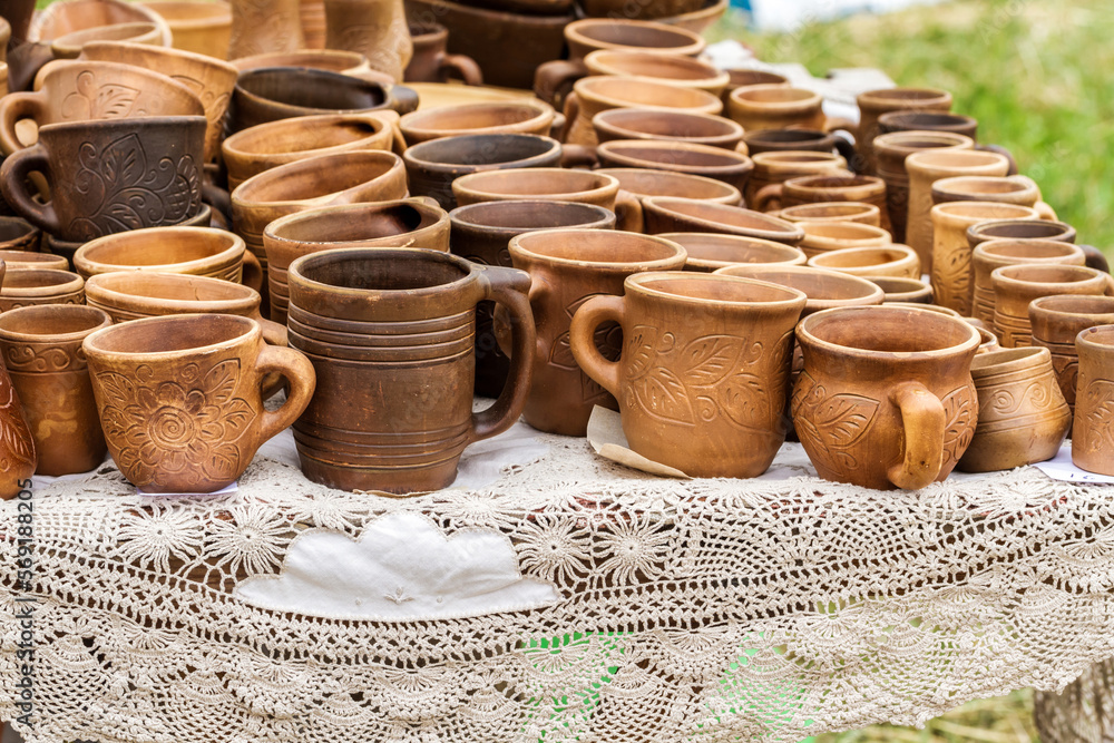 Heap of different clay cups on the table