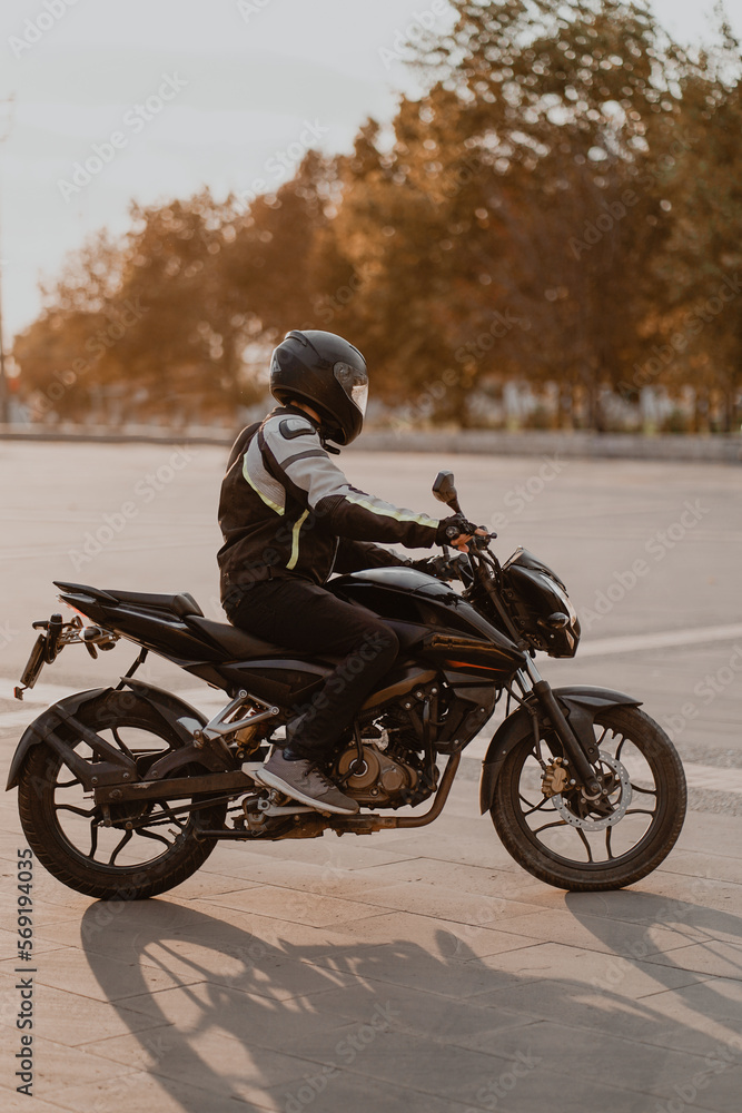 Obraz premium rider on a black motorcycle with black helmet
