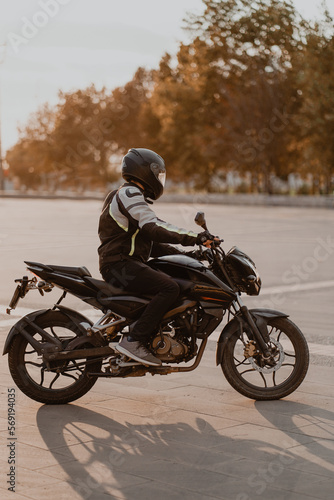 rider on a black motorcycle with black helmet