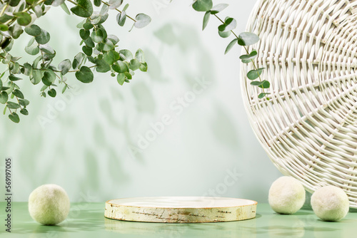 Empty wooden podium with laundry balls on blue background with eucalyptus leaves. Natural display for presentation. Eco friendly showcase for new home cleaning or laundry products and promotion sale photo