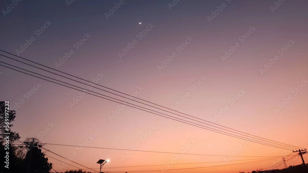 Low angle view of power lines at sunset