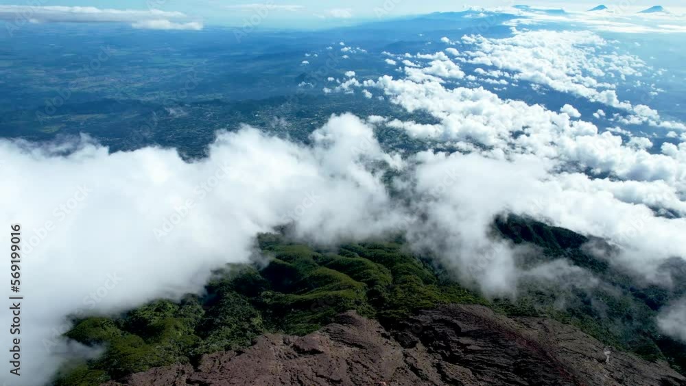 Panorama of flowing fog waves on mountain tropical rainforest, image over the clouds Amazing nature background with clouds and mountain peaks in Purbalingga. Panorama of flowing fog waves on mountain tropical rainforest, image over the clouds Amazing nature background with clouds and mountain peaks in Purbalingga.