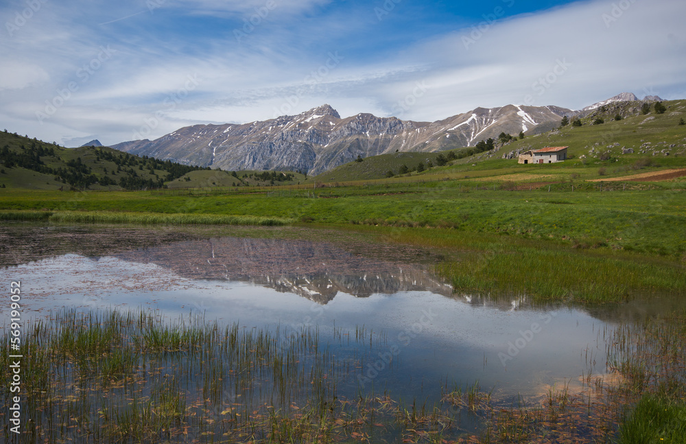 View of beautiful lake with the reflection of the mountain in Abruzzo during spring season, Italy