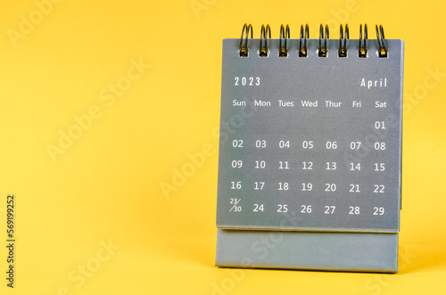 The April 2023 desk calendar for 2023 year on yellow color background.