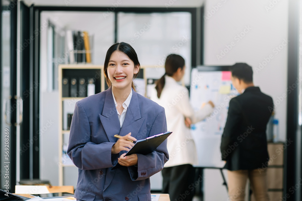 Confident business expert attractive smiling young woman holding digital tablet on desk in office. Confident business expert attractive smiling young woman holding digital tablet on desk in office.
