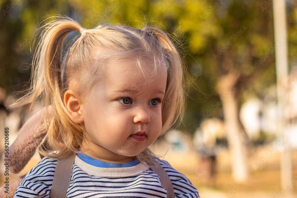 Little child with backpack at playground in sun Little child with backpack at playground in sun