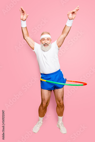Fotografia Emotional cool cheerful excited crazy funny fooling playful gymnast grandpa with comic grimace, exercises for fit figure