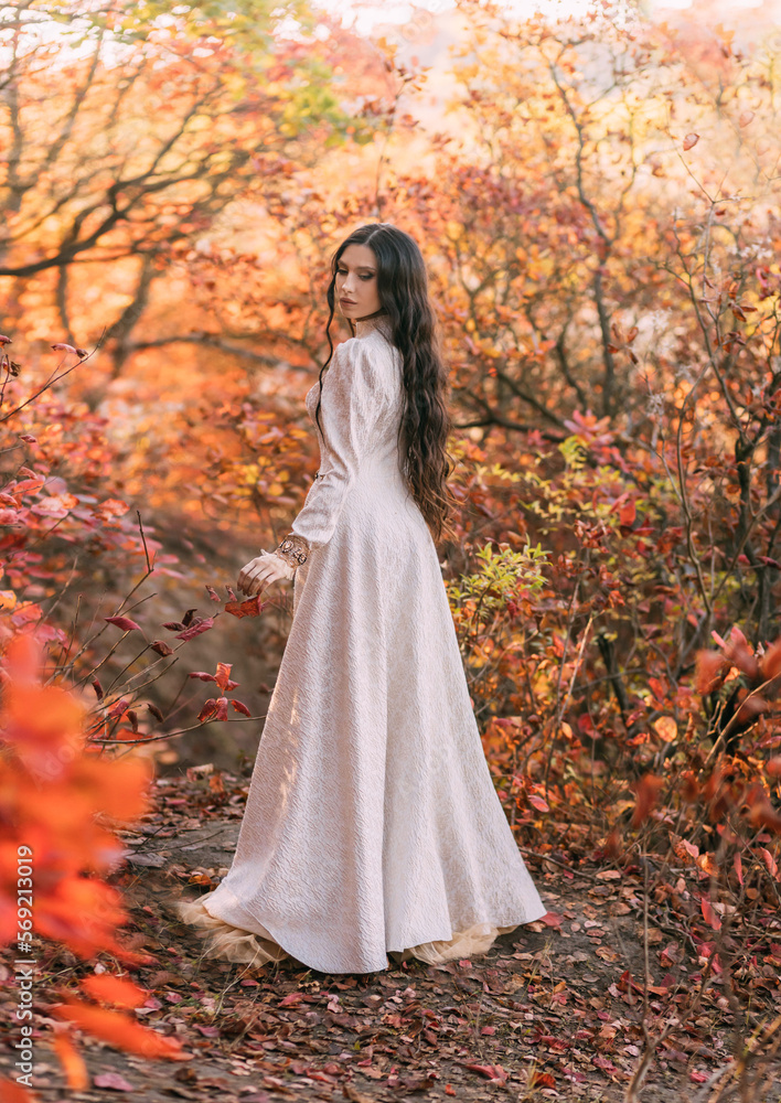 Mystery art portrait fantasy woman queen walking in gothic autumn forest, white vintage style dress. Girl princess long wavy hair sexy lady looks back rear view. Red orange yellow color dark tree park