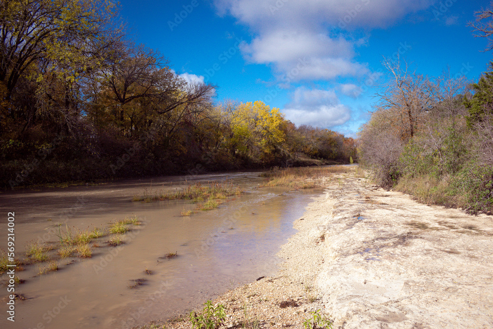 River flowing through limestone in Texas during fall.