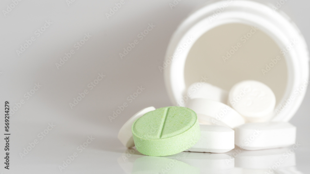 white pills on green background white pills on green background