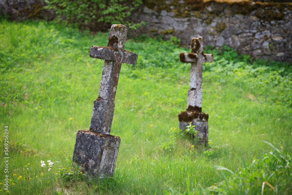 old stone crosses in a cemetery among spring greenery, Roztocze Wschodnie old stone crosses in a cemetery among spring greenery, Roztocze Wschodnie