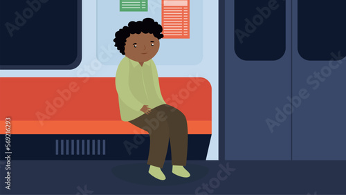 A man sits by himself on a seat in the subway