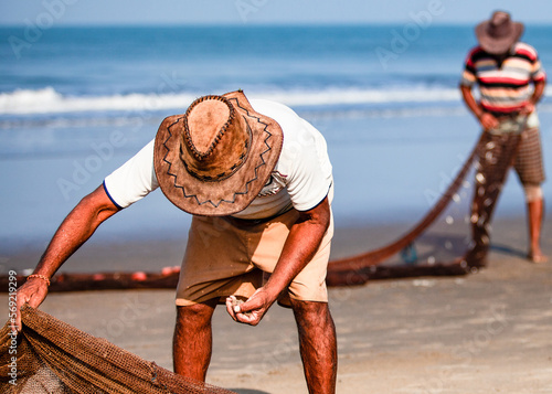 Morjim, North GOA, India, 29 March 2016: fisherman in a hat. photo