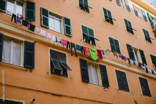 Linen, clothes are dried on a rope, hanging on the facade of the building between the windows. Old Europe