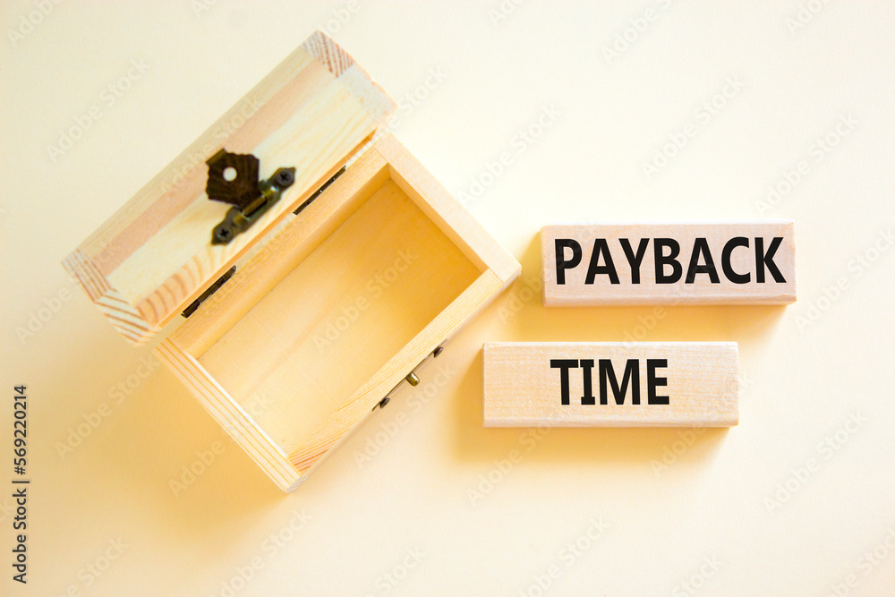Payback time symbol. Concept words Payback time on wooden blocks. Beautiful white table white background. Wooden empthy chest. Business and payback time concept. Copy space. Payback time symbol. Concept words Payback time on wooden blocks. Beautiful white table white background. Wooden empthy chest. Business and payback time concept. Copy space.