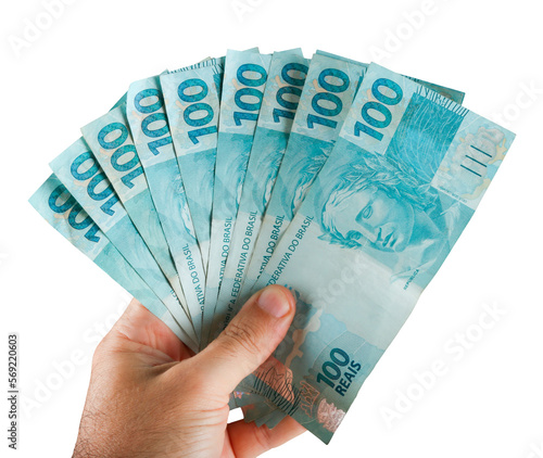 Brazilian money. Hand holding one hundred reais banknotes photo