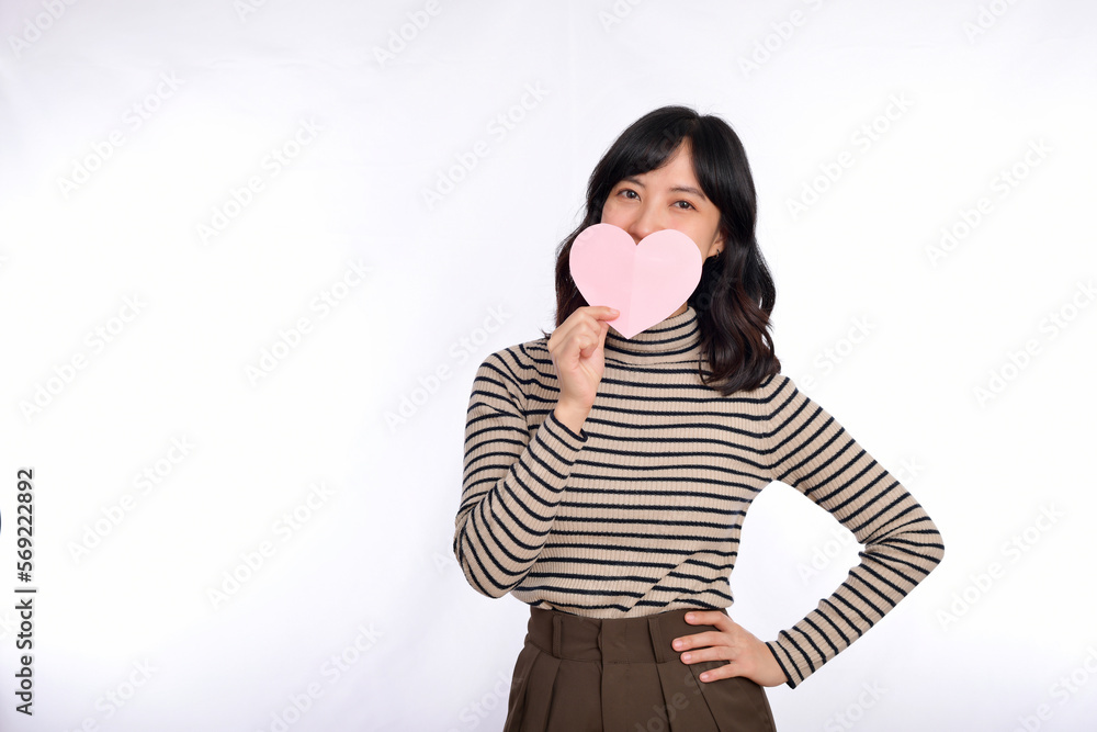 Beautiful young asian woman holding a paper heart while standing against white background. Beautiful young asian woman with paper heart. Beautiful young asian woman holding a paper heart while standing against white background. Beautiful young asian woman with paper heart.