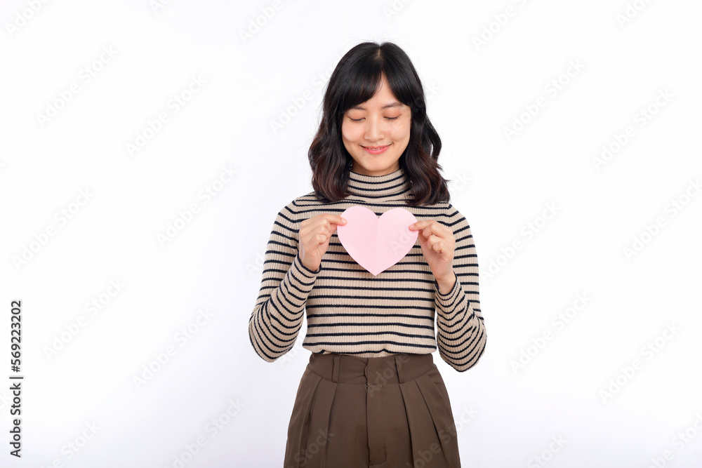 Beautiful young asian woman holding a paper heart while standing against white background. Beautiful young asian woman with paper heart. Beautiful young asian woman holding a paper heart while standing against white background. Beautiful young asian woman with paper heart.
