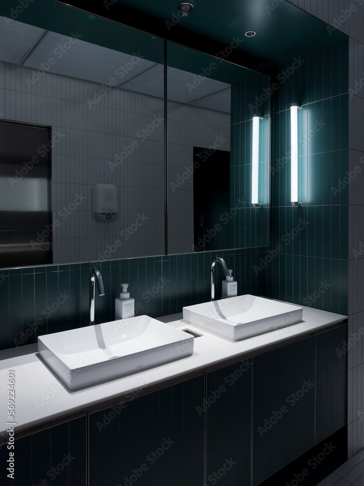 Fototapeta premium Contemporary interior of public toilet with Green tile walls