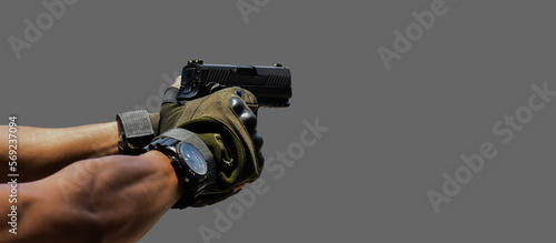 Photos Isolated 9mm pistol gun holding in right hand of gun shooter with clipping paths