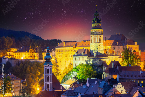 Cesky Krumlov, Czech Republic. Amazing Bright Starry Sky Castle Tower And Old Town Cityscape Skyline. Famous Landmark In Autumn Evening Night Scenic View. Unesco World Heritage Site.