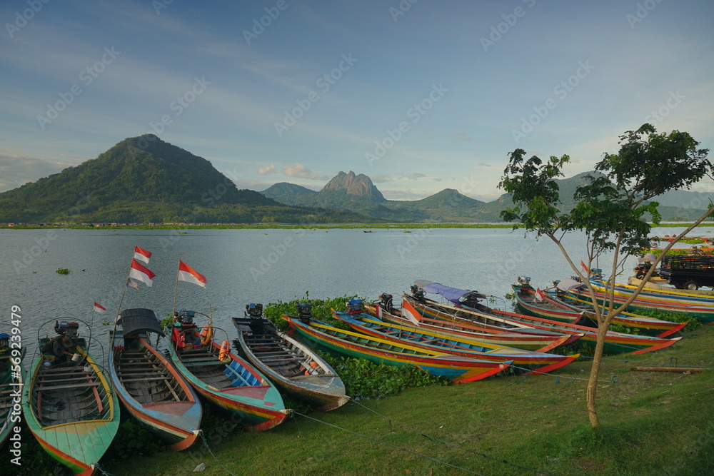 Fishing boats anchored at the Jatiluhur reservoir. Beautiful view of Jatiluhur reservoir with mountains in the background.