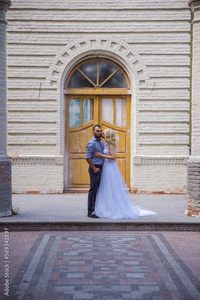 Bride and groom in front of an old house