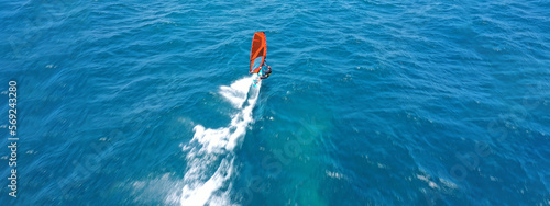 Aerial drone ultra wide panoramic photo with copy space of wind surfer cruising in high speed in tropical ocean bay with deep blue see © aerial-drone