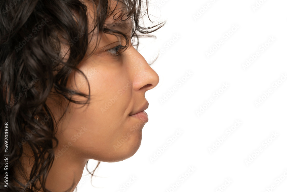 close up, profile, side view of beautiful young indian woman without makeup on a white background close up, profile, side view of beautiful young indian woman without makeup on a white background