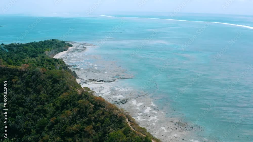 Mayotte - Flying above a path along the sea and discovering a beautiful landscape made with beach, turquoise water and coral reef Mayotte - Flying above a path along the sea and discovering a beautiful landscape made with beach, turquoise water and coral reef