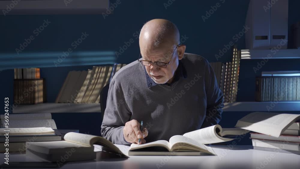 Close-up shot of senior old man in glasses holding and reading an old book.
Professional elderly male historian works with scientific books in his work, takes notes.
Close-up shot of senior old man in glasses holding and reading an old book.
Professional elderly male historian works with scientific books in his work, takes notes.