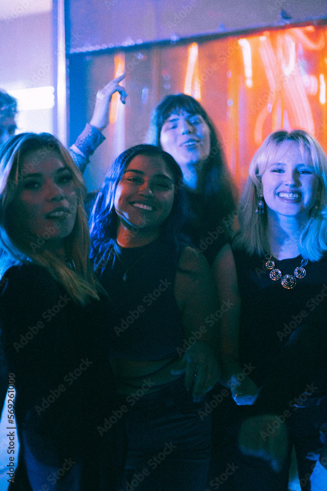 Portrait of happy young multiracial women enjoying together at nightclub Portrait of happy young multiracial women enjoying together at nightclub