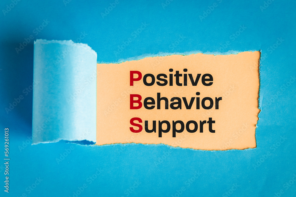 Positive behavior support symbol. text appearing behind torn paper, blue background, concept words support positive behavior Business, psychological and positive behavior support concept.