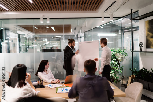 Group of businesspeople holding briefing in meeting room © BullRun