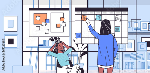 businesswomen couple scheduling work agenda on weekly meeting schedule task board girls discussing during meeting