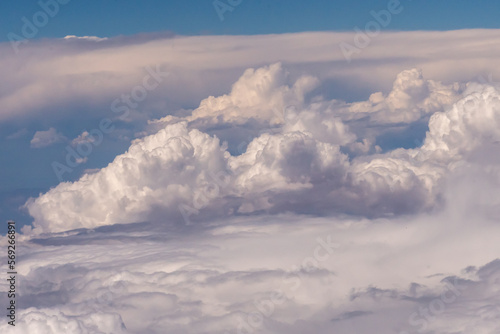 Aerial view of large puffy clouds outside of my airplane window