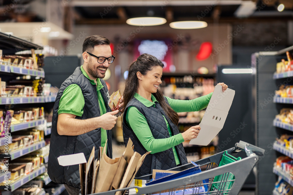 The supermarket workers are working with groceries at marketplace. The supermarket workers are working with groceries at marketplace.