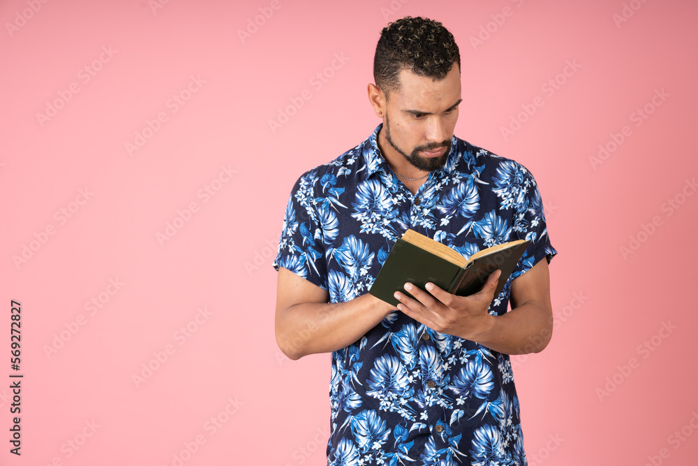 Serious and surprised man reading a book