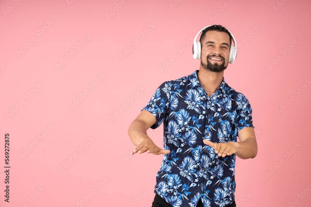 Happy man feeling the music and dancing with his headphones Happy man feeling the music and dancing with his headphones