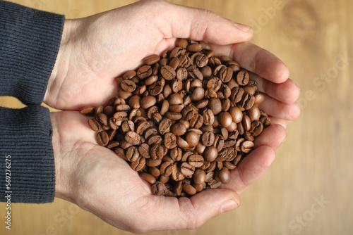 coffee beans held in hands