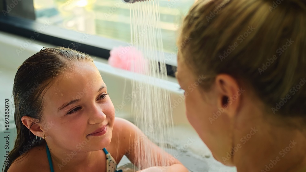 Funny mother and daughter having fun in bathroom. Perfect mother