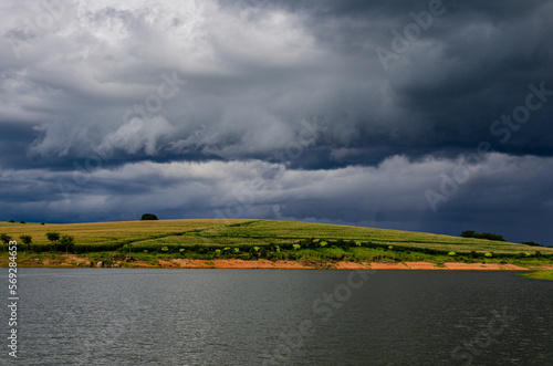 landscape with river and clouds, dramatic, background, storm, corn field